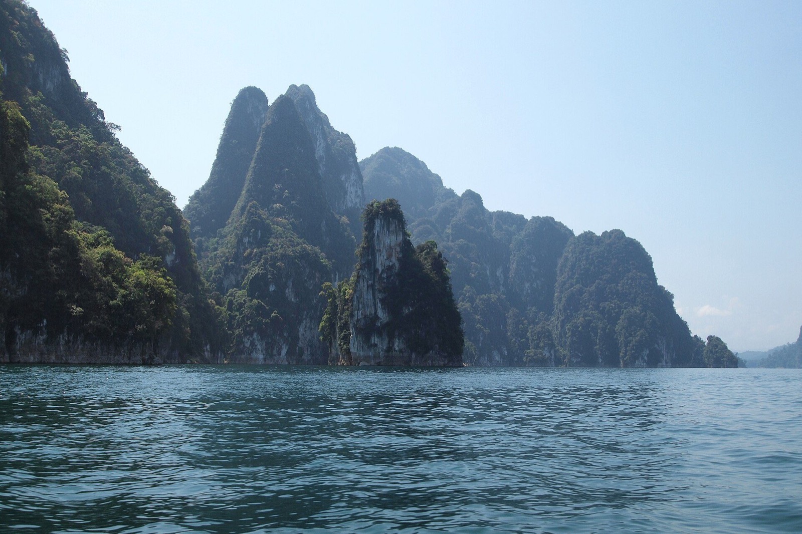 Longtail boats beneath limestone peaks on Cheow Lan Lake